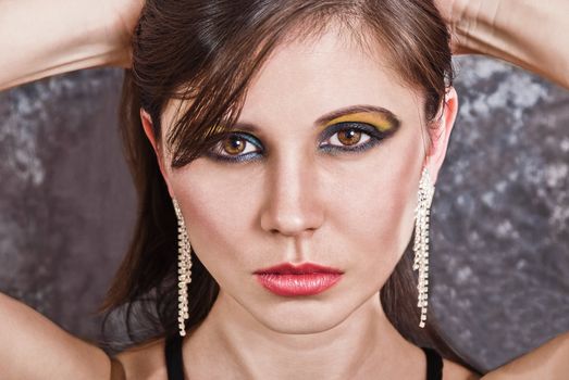 Closeup portrait of an attractive woman. Fashion studio shot