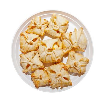 Delicious crunchy sweet puffs in a bowl on the isolated background.