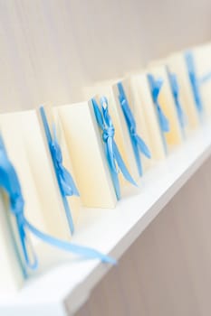 many blank invitation cards standing in a row