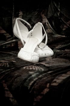  white bride wedding shoes on a dark background