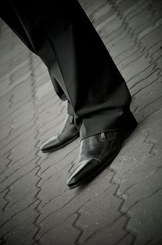 standing imposing man in a patent leather shoes. legs only. businessman classical Well-dressed clothing 