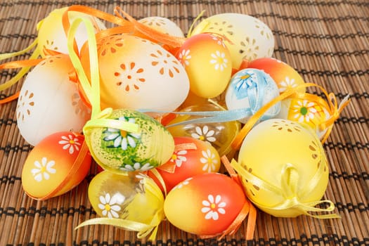 Bright color easter eggs with bows on wooden desk