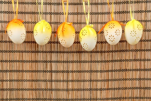 Bright color easter eggs with bows on wooden background