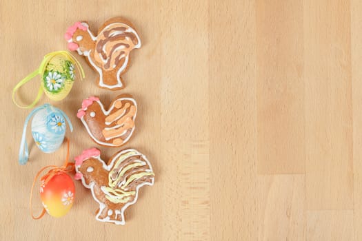 Easter ginger breads and painted egg on wooden background