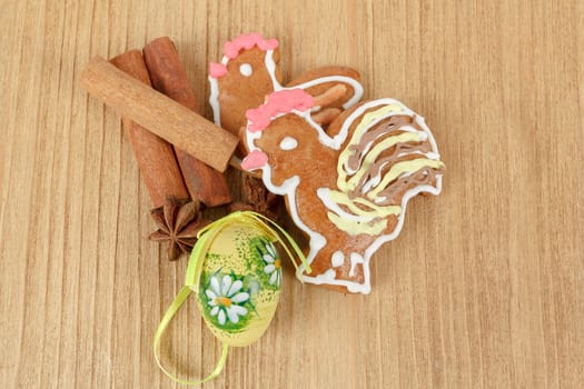 Easter ginger breads and cinnamon on wooden background