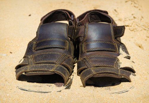 two sandals to sprinkle with sand. Heat summer background