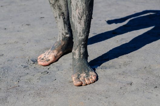 take a mud cure. healthy medical procedure. dirty legs