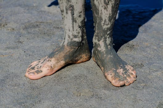 take a mud cure. healthy medical procedure. dirty legs