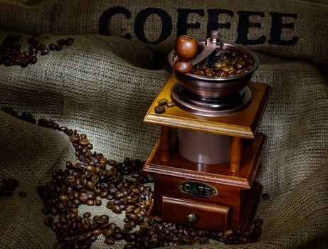 Coffee Mill with beans and burlap. still life