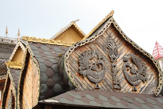 Decorative element of traditional wooden Russian architecture with carved birds
