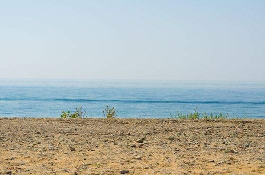 silence seashore. Blue haze horizon view. Water blur background