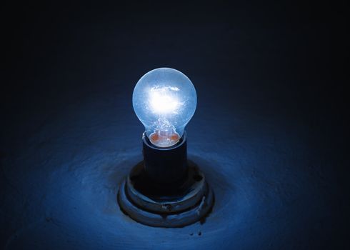 old blue lamp lighting in a dark room