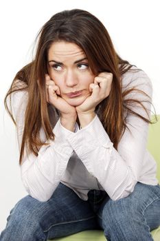 Portrait of pensive woman sitting on a chair