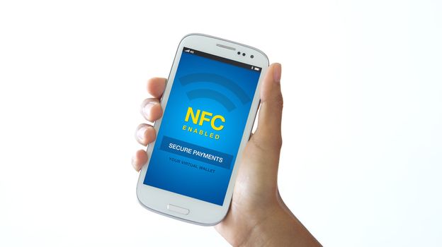 A person holding a NFC enabled mobile phone.