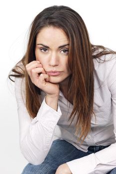 Portrait of pensive young woman sitting on a chair