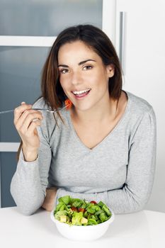 beautiful girl eating healthy food at home