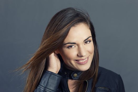 Glamour portrait of beautiful woman model with hand in hair