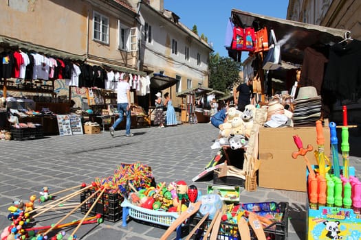 BRASOV, ROMANIA - AUGUST 21: Tourists shop at souvenir stalls on August 21, 2012 in Brasov, Romania. Brasov is a popular tourism destination with 581,983 arrivals in Brasov County in 2008.