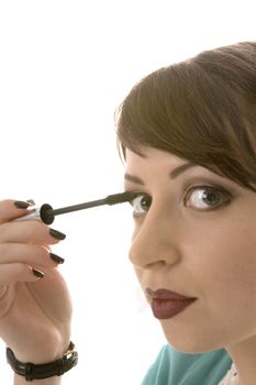the beautiful young girl makes up eyelashes, 
a portrait on a white background