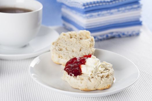 Scone with clotted cream and strawberry jam/preserves.