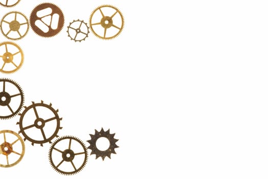 Cogs and other watch parts isolated on white background with copy space.