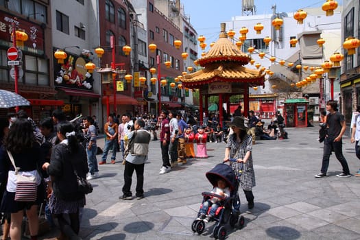 KOBE, JAPAN - APRIL 24: Visitors enjoy sunny weather in Chinatown on April 24, 2012 in Kobe, Japan. Nankinmachi, Kobe's Chinatown is the 2nd largest in Japan and a popular tourism attraction.