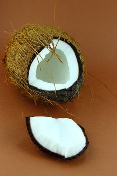 fresh Coconuts with parts on brown background