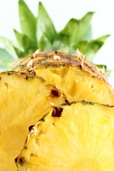 ripe pineapple with slices isolated on white background