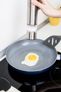 Woman salt egg in a frying pan