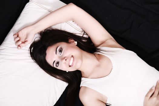 A young hispanic Woman sleeping on the Bed.