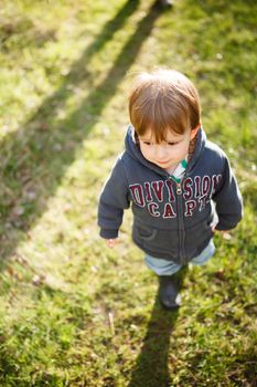 Little infant walking in the golden hour