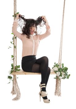 Woman joyfully shouts ruffled his hair, sitting on a swing.