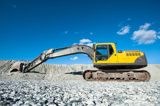 A yellow earthmover parked on the building site