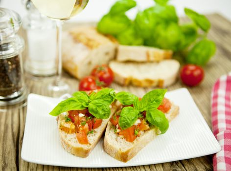 fresh tasty italian bruschetta with tomato on wooden background