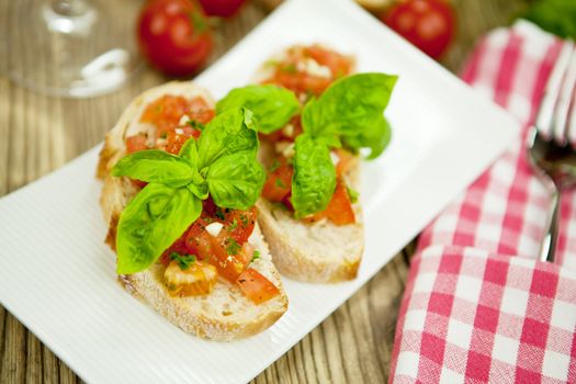 fresh tasty italian bruschetta with tomato on wooden background