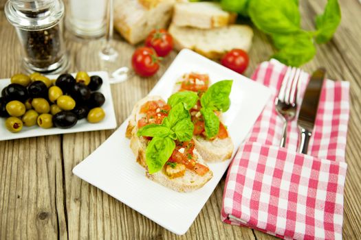 fresh tasty italian bruschetta with tomato on wooden background