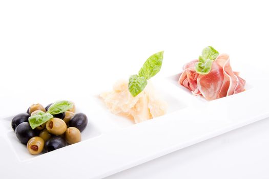 deliscious antipasti plate with parma parmesan and olives isolated on white background