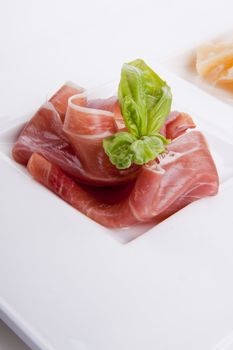 deliscious antipasti plate with parma parmesan and olives isolated on white background