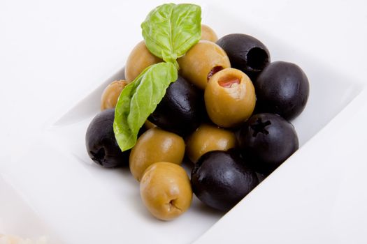 deliscious antipasti plate with parma parmesan and olives isolated on white background