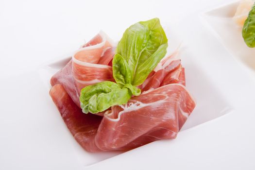 deliscious antipasti plate with parma parmesan and olives isolated on white background