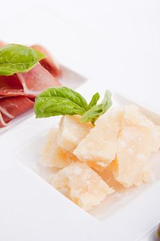 deliscious antipasti plate with parma parmesan and olives isolated on white background