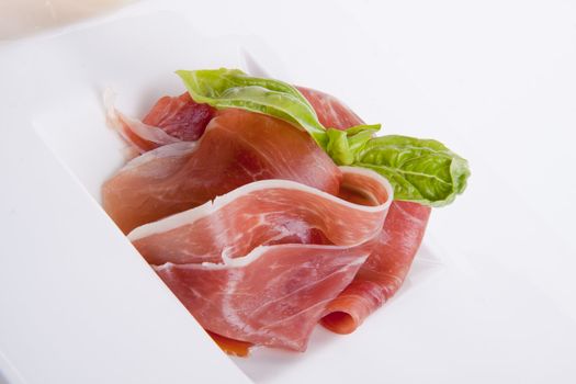 deliscious antipasti plate with parma parmesan and olives isolated on white background