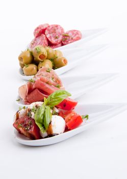 deliscious antipasti plate with parma parmesan and olives isolated on white background