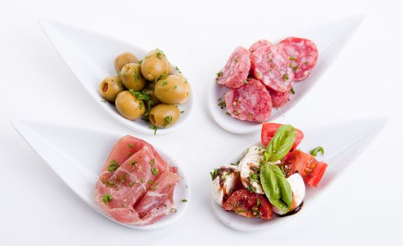 deliscious antipasti plate with parma parmesan and olives isolated on white background