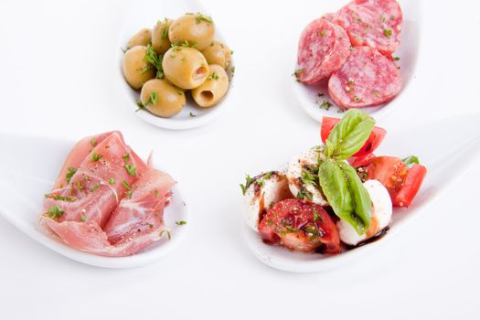 deliscious antipasti plate with parma parmesan and olives isolated on white background