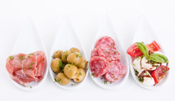 deliscious antipasti plate with parma parmesan and olives isolated on white background