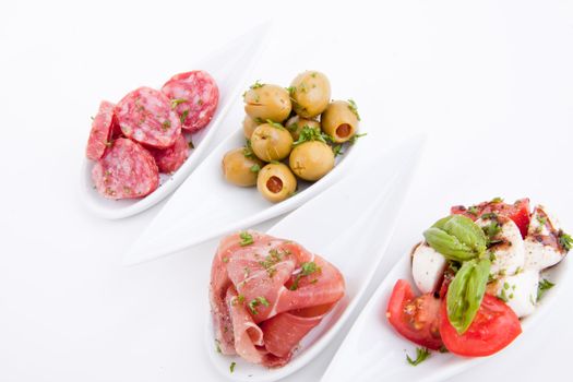 deliscious antipasti plate with parma parmesan and olives isolated on white background