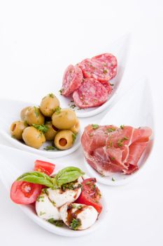 deliscious antipasti plate with parma parmesan and olives isolated on white background