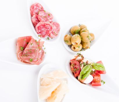 deliscious antipasti plate with parma parmesan and olives isolated on white background