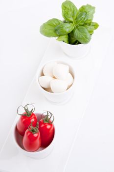 tasty tomatoe mozarella salad with basil isolated on white background